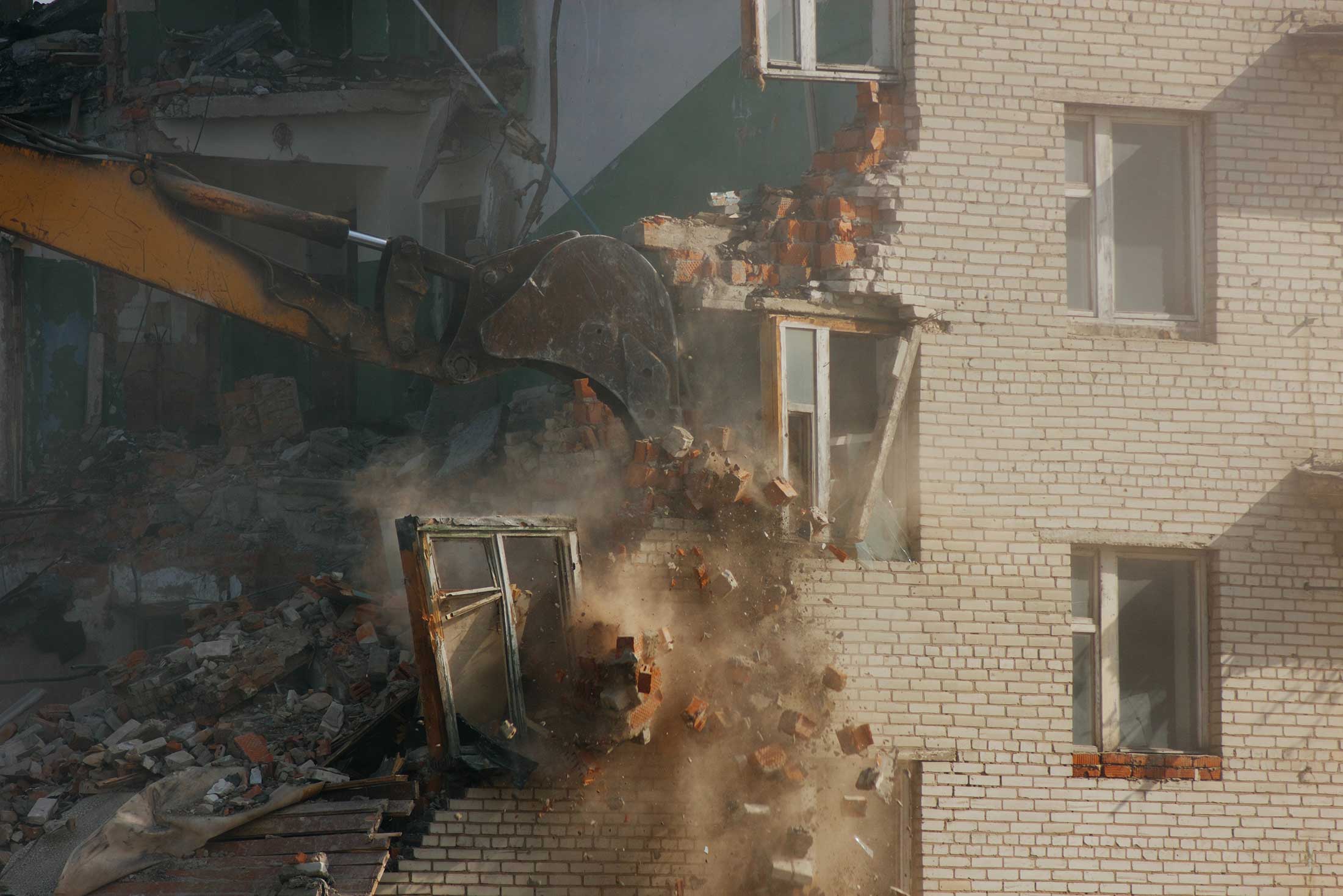 digger demolishing an old house